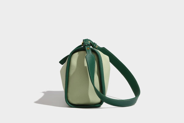 Structured two-tone shoulder bag with pebbled leather-look finish, contrast trim, top zip closure, and gold-tone hardware