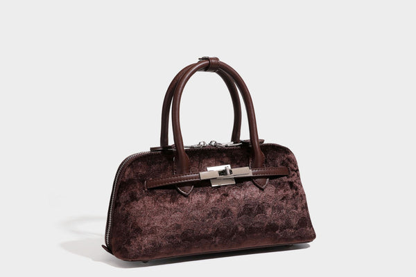 Small structured satchel bag in dark brown velvet-like textured finish with leather-look trim, silver-tone turn-lock bar