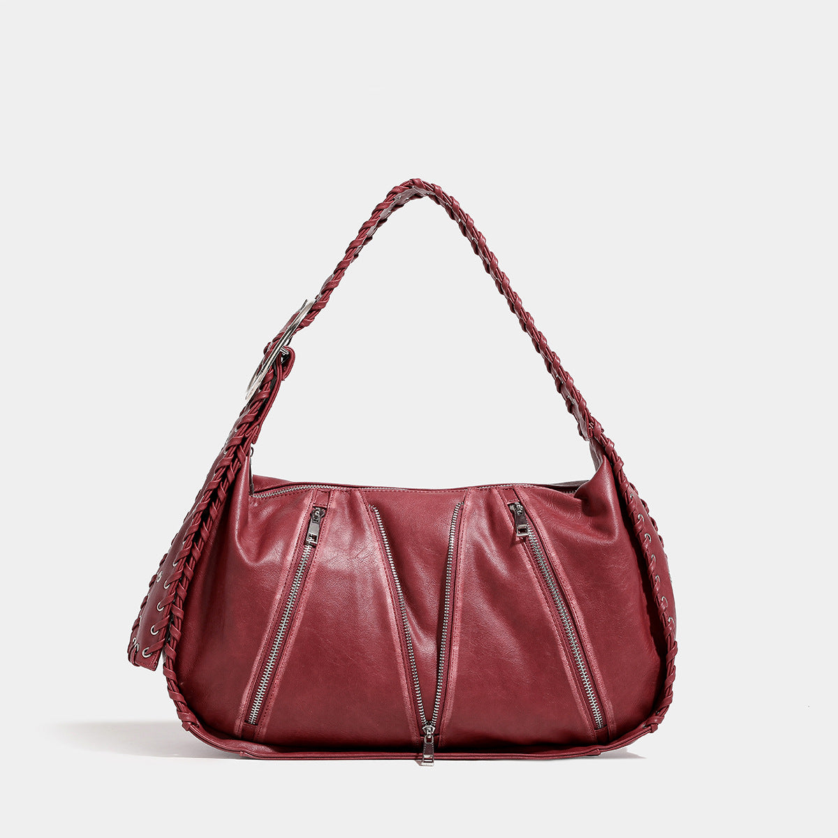 Slouchy hobo shoulder bag with wide braided eyelet strap, multiple front zip compartments, and silver-tone ring buckle, front