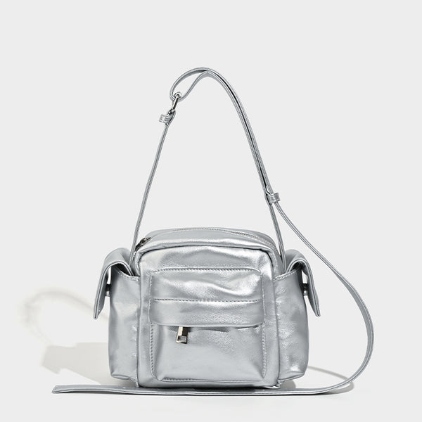 Boxy leather-look crossbody bag with front zip pockets, top zip closure, and long adjustable strap, front view