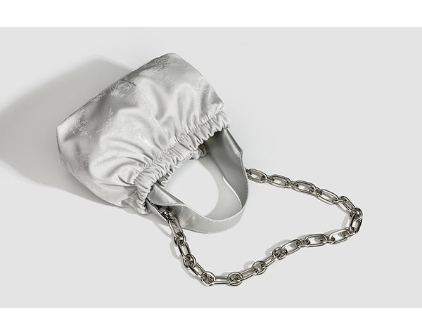Small ruched satin-finish cloud bag with elasticized drawstring top, short top handle, and chunky silver-tone chain strap