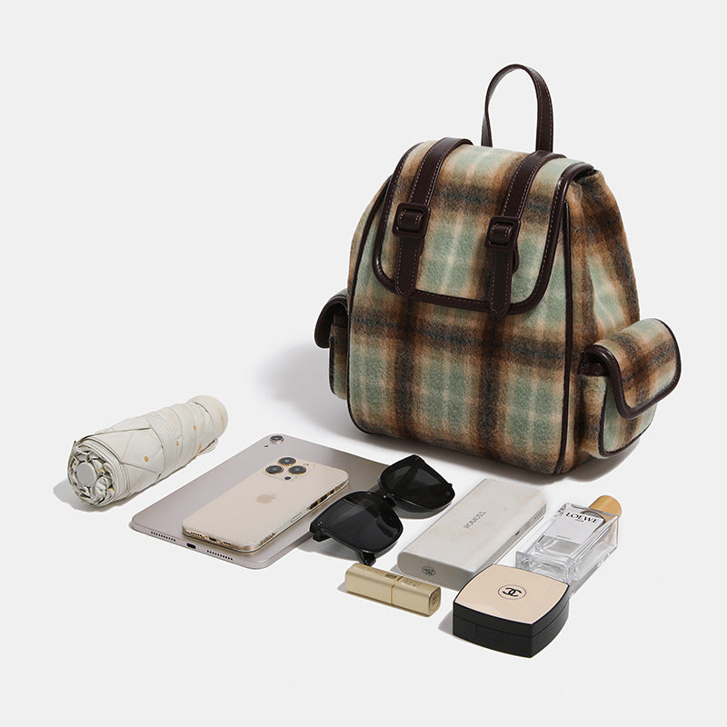 Compact vintage plaid backpack in khaki and sage check with dark leather-look trim, buckle flap closure, and adjustable