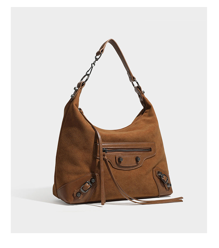 Slouchy suede-finish hobo shoulder bag with dark hardware, exterior zip pocket, tassel ties, and detachable crossbody strap
