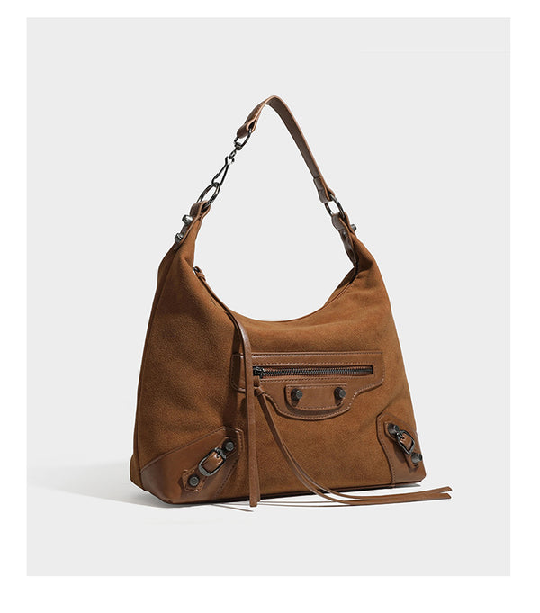 Slouchy suede-finish hobo shoulder bag with dark hardware, exterior zip pocket, tassel ties, and detachable crossbody strap