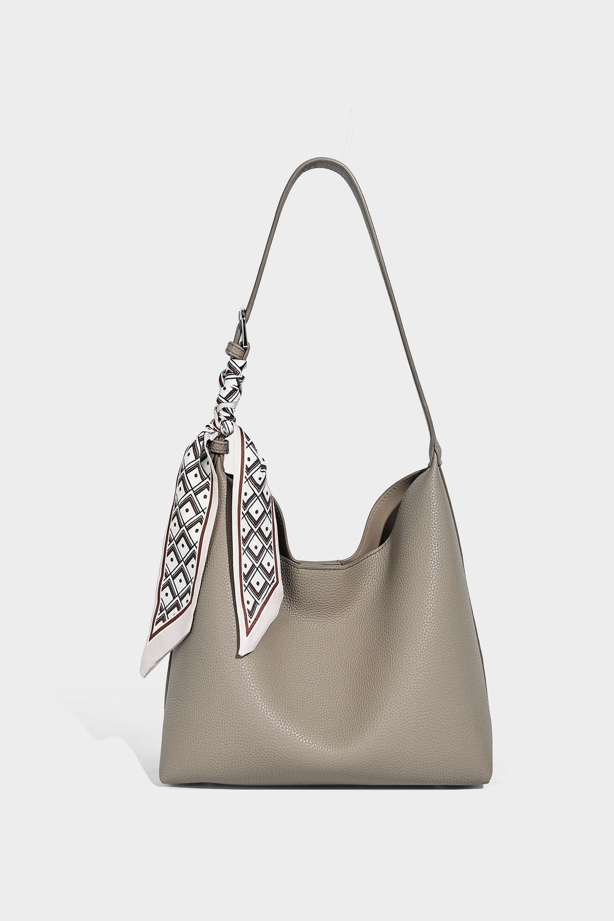 Soft slouchy hobo shoulder bag in pebbled matte finish with slim strap, silver-tone ring hardware, and knotted printed scarf