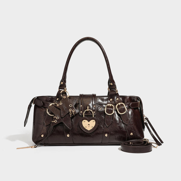 Dark brown glossy crinkled leather-look barrel bag with gold heart lock, dome studs, star charm, dual top handles and, detail