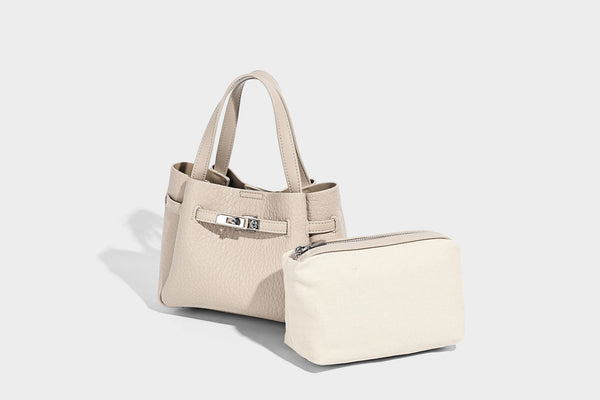 Small structured pebbled bucket tote with double top handles, silver turn-lock hardware, and detachable shoulder strap