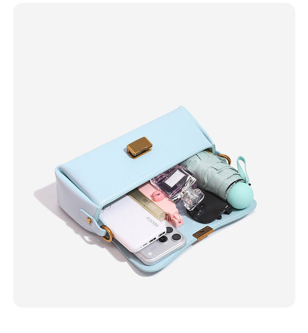 Structured rectangular baguette shoulder bag in pastel sky blue with smooth leather-look finish, ribbed gold-tone turn-lock