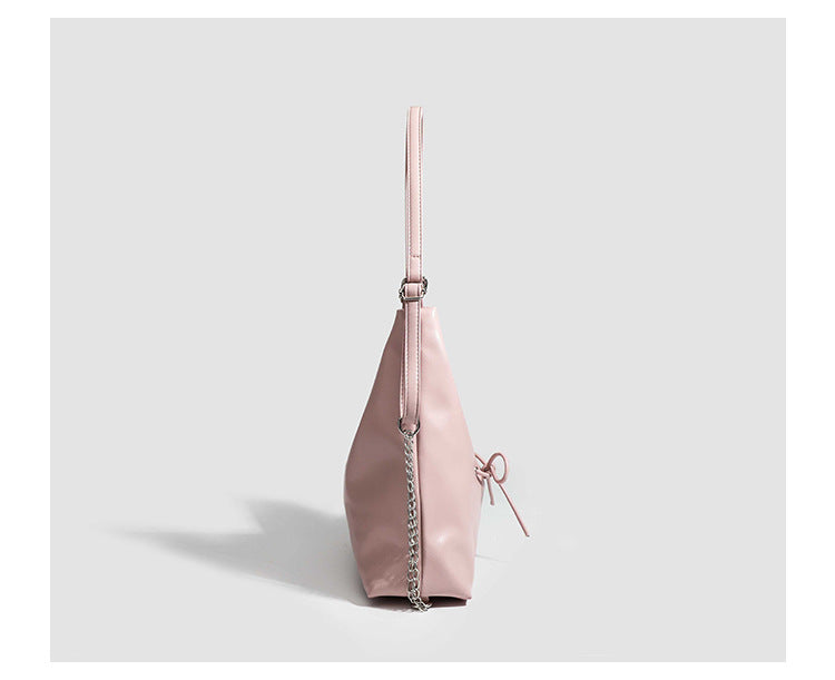 Glossy leather-look hobo shoulder bag with front bow lacing detail and silver-tone chain strap, detail view 19