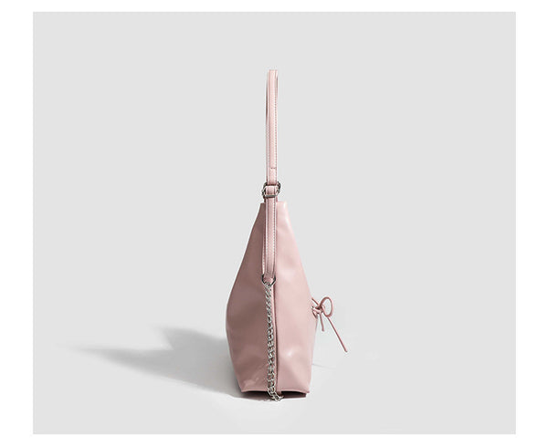Glossy leather-look hobo shoulder bag with front bow lacing detail and silver-tone chain strap, detail view 19