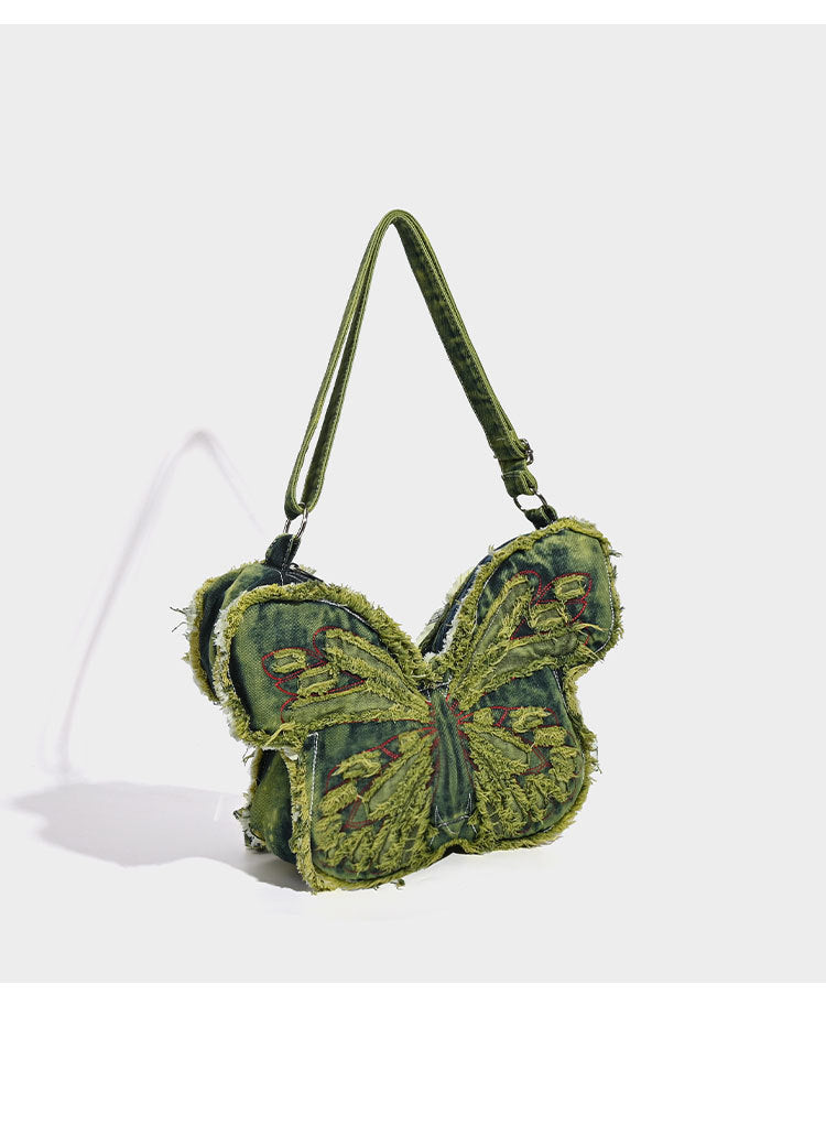 Butterfly-shaped distressed denim shoulder bag with frayed raw edges and embroidered wing panels, detail view 8