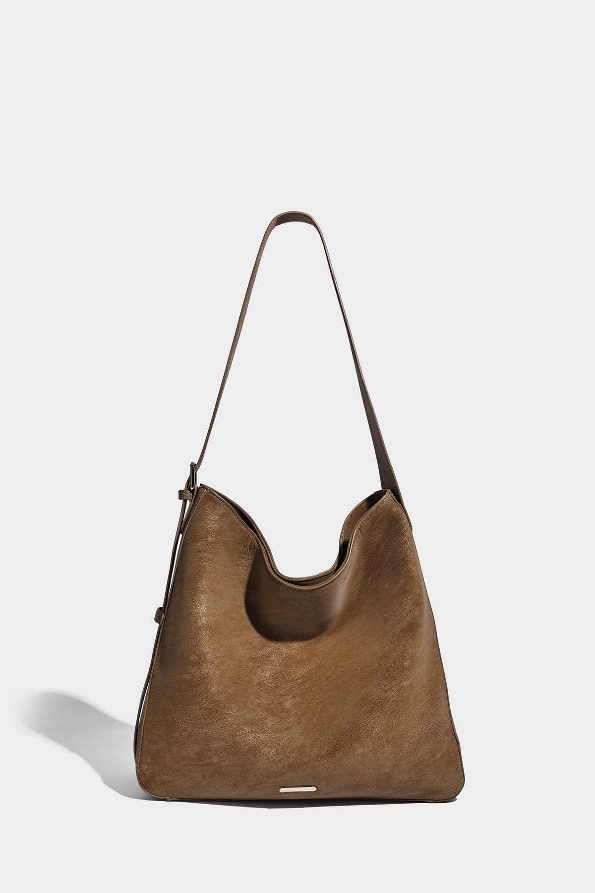 Large slouchy hobo shoulder bag in matte leather-look finish with adjustable strap and gold-tone bar hardware, detail view 13