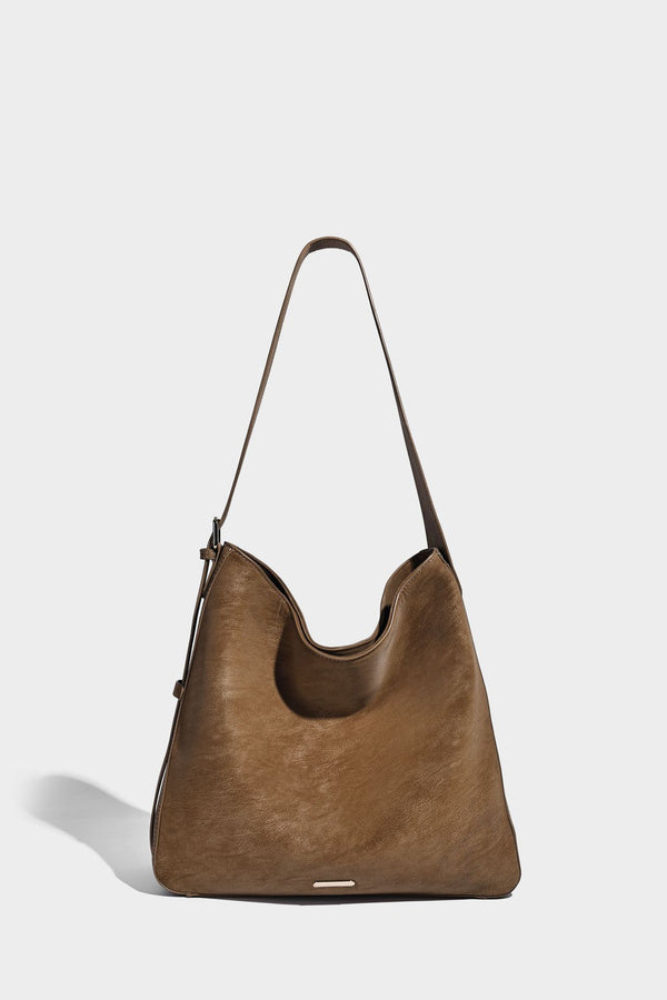 Large slouchy hobo shoulder bag in matte leather-look finish with adjustable strap and gold-tone bar hardware, detail view 13