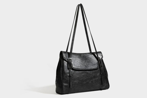 Structured flap-top shoulder tote bag in distressed leather-look finish with silver-tone buckle hardware and double shoulder