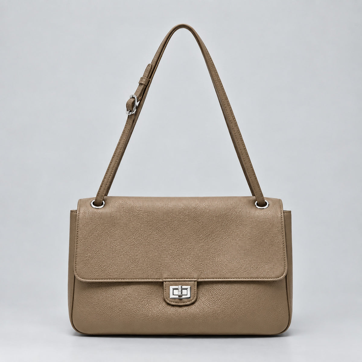 Structured black flap shoulder bag with pebbled texture, silver-tone turn-lock closure, and adjustable single shoulder strap