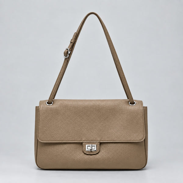 Structured black flap shoulder bag with pebbled texture, silver-tone turn-lock closure, and adjustable single shoulder strap