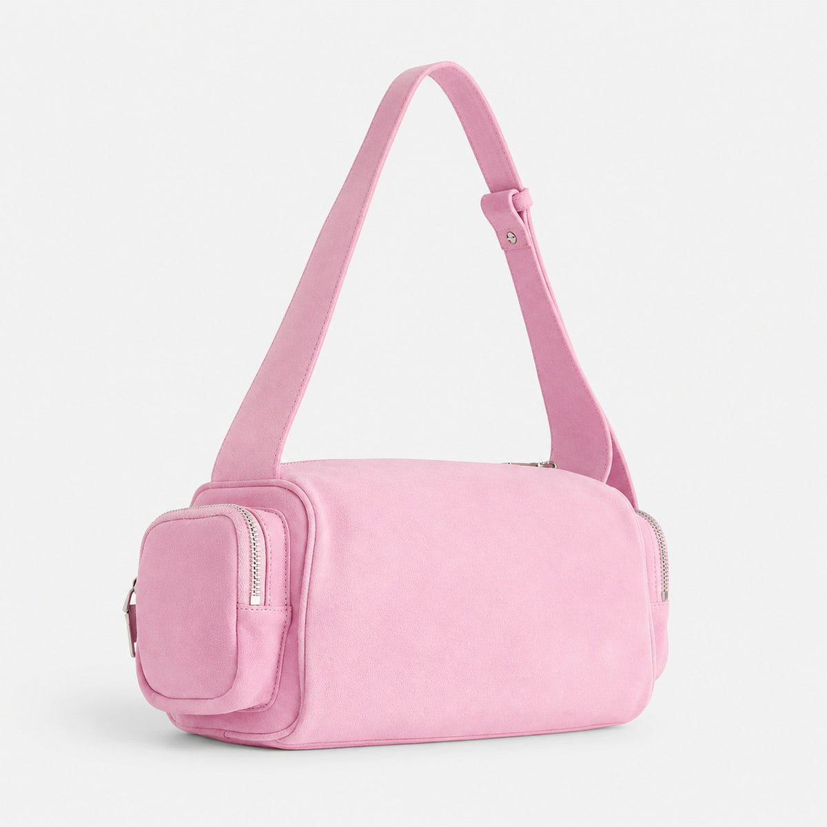 Mini barrel shoulder bag with side zip pouches and adjustable strap in pink suede-like finish, front view