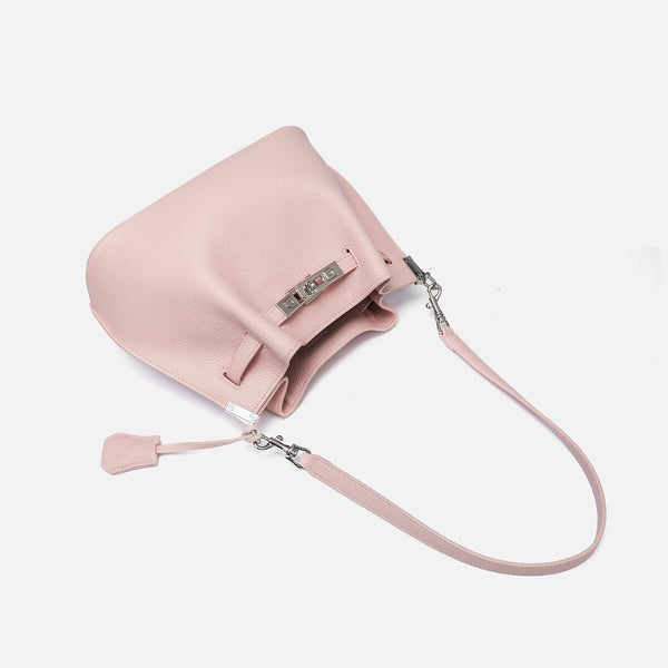 Soft-structured pebbled leather-look bucket bag with silver turn-lock front clasp and adjustable crossbody strap, detail view