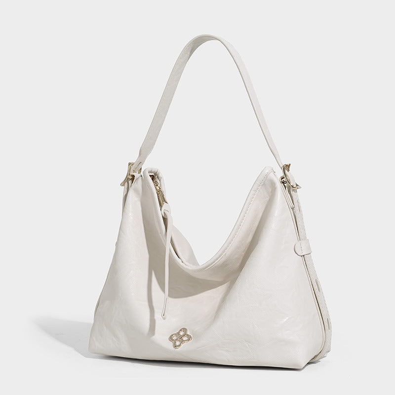 Slouchy leather-look hobo shoulder bag with gold-tone hardware and adjustable strap in brown, detail view 6