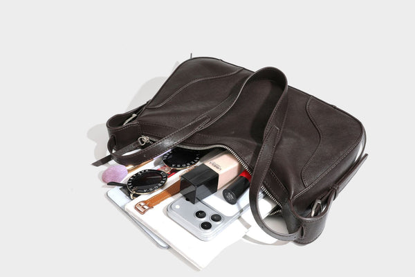 Slouchy crescent hobo shoulder bag in dark brown pebbled leather-look finish with zip top and long shoulder strap, detail