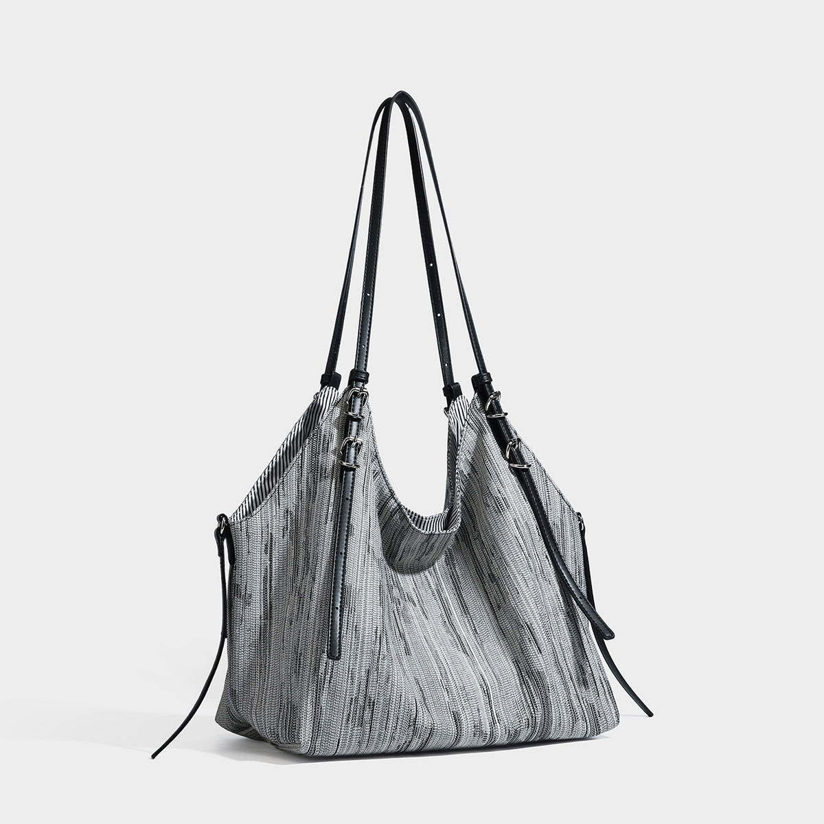 Large slouchy woven-texture shoulder tote bag with slim leather-look straps, side cinch ties, and silver-tone hardware