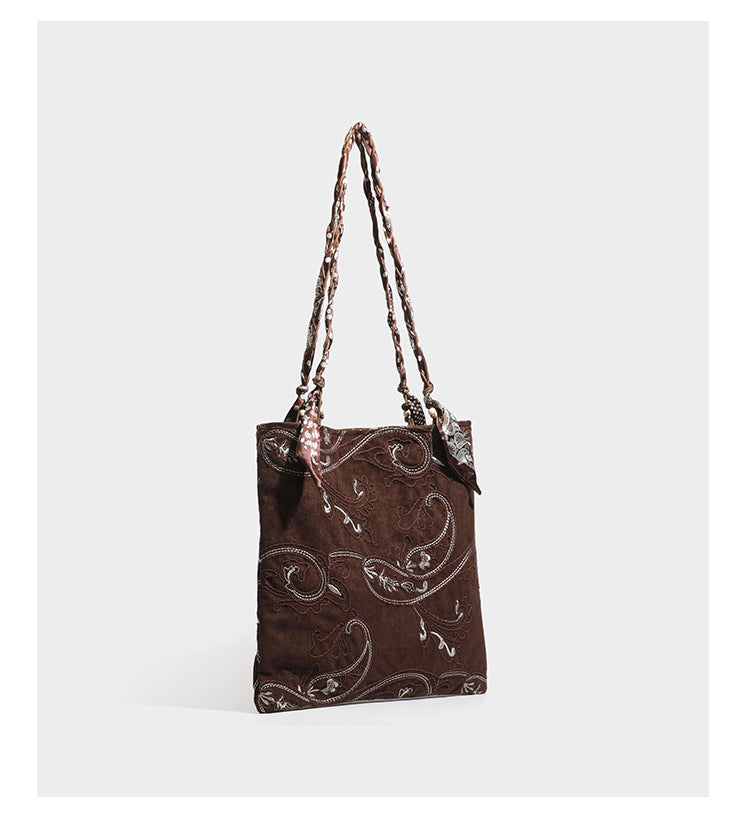Brown suede-finish tote bag with paisley embroidery and braided fabric-ribbon shoulder strap, detail view 11
