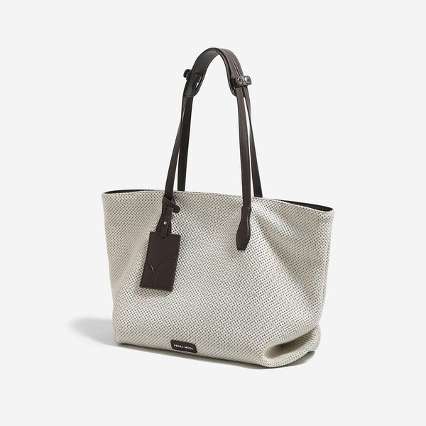 Off-white speckled woven tote bag with dark brown leather-look shoulder straps, zip closure, and hanging rectangular tag
