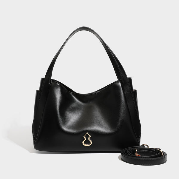 Structured glossy leather-look tote shoulder bag with dual top handles, detachable crossbody strap, side pockets, and, detail