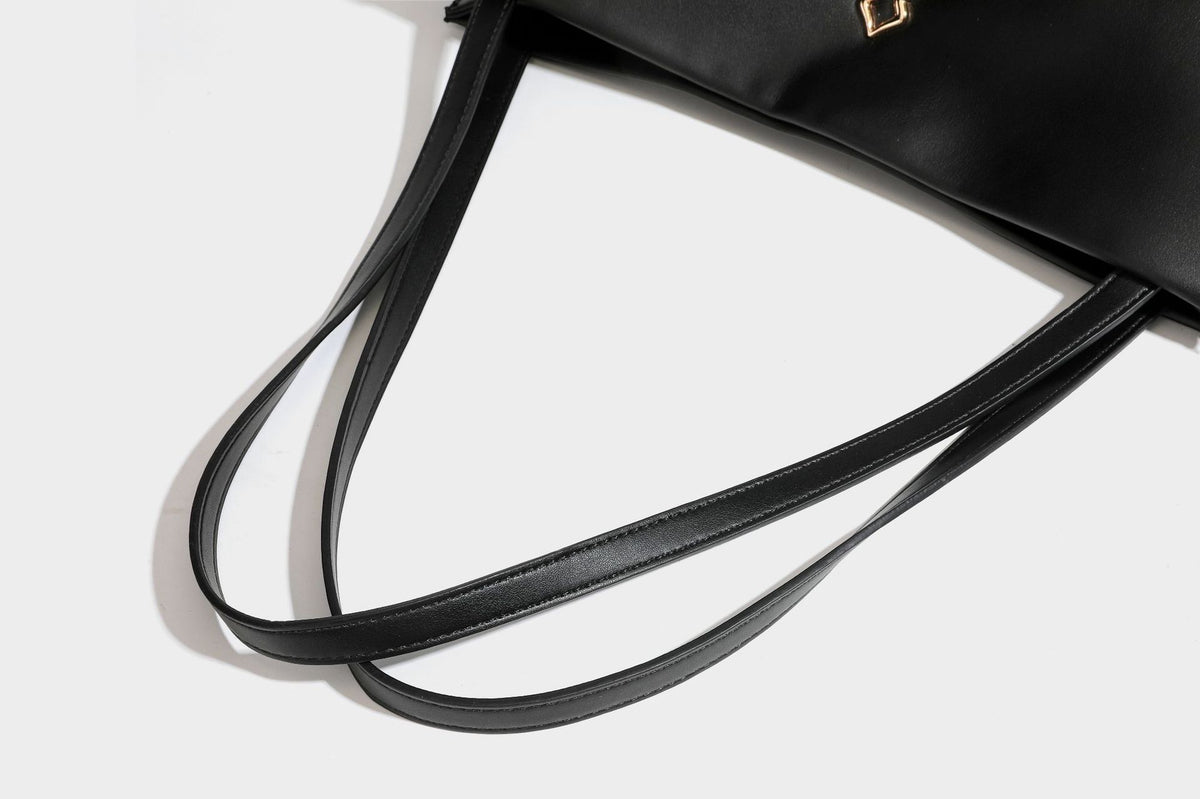 Structured rectangular shoulder tote bag with smooth leather-look finish, long double straps, and gold-tone gourd emblem on