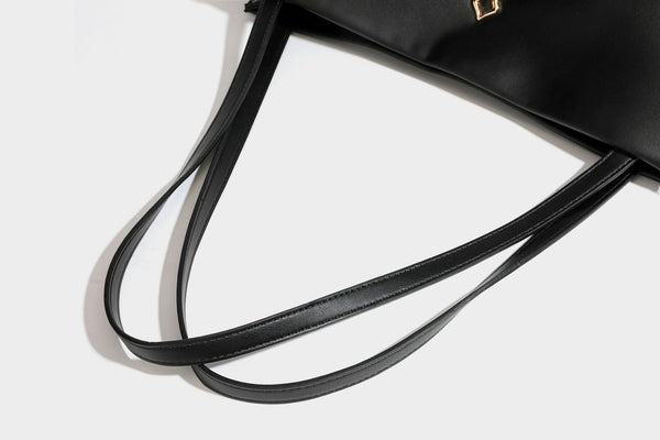 Structured rectangular shoulder tote bag with smooth leather-look finish, long double straps, and gold-tone gourd emblem on