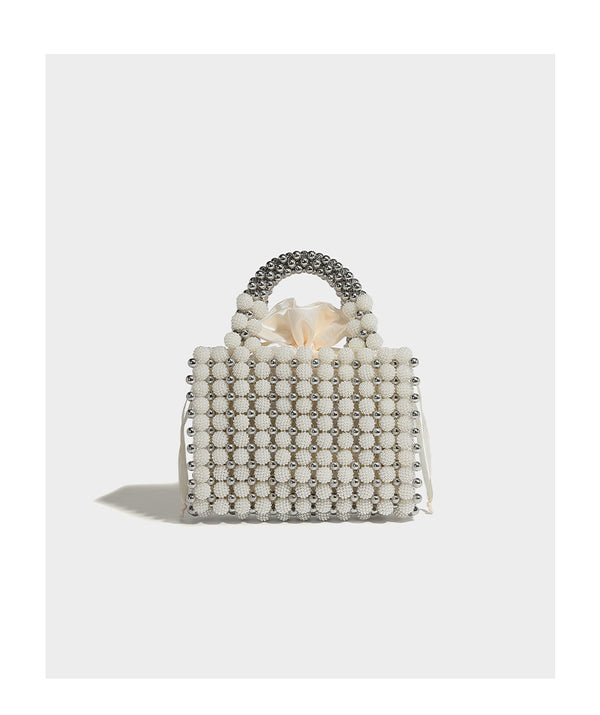 Small boxy pearl-bead mini top-handle bag with silver metallic bead accents, satin floral detail, and long beaded shoulder