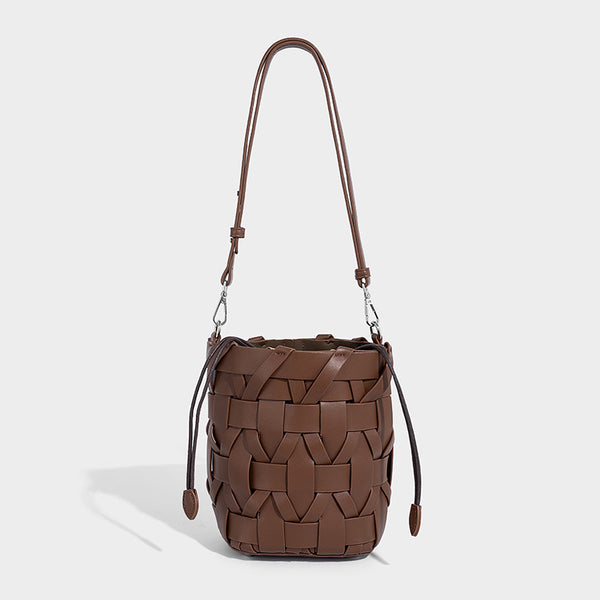 Small woven leather-look bucket bag with interlaced strip exterior, drawstring closure, and adjustable crossbody strap