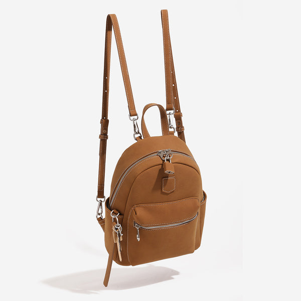 Small rounded mini backpack handbag in pebbled leather-look finish with front zip pocket, silver-tone hardware, and, detail