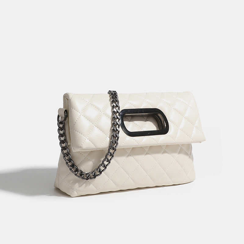 Quilted diamond-stitch flap crossbody bag with gunmetal chain strap and cut-out bar handle, detail view 7