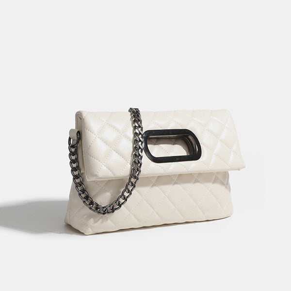 Quilted diamond-stitch flap crossbody bag with gunmetal chain strap and cut-out bar handle, detail view 7