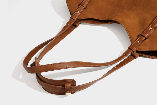 Oversized suede-finish tote shoulder bag in caramel brown with slim leather-look straps and gold-tone logo hardware, detail