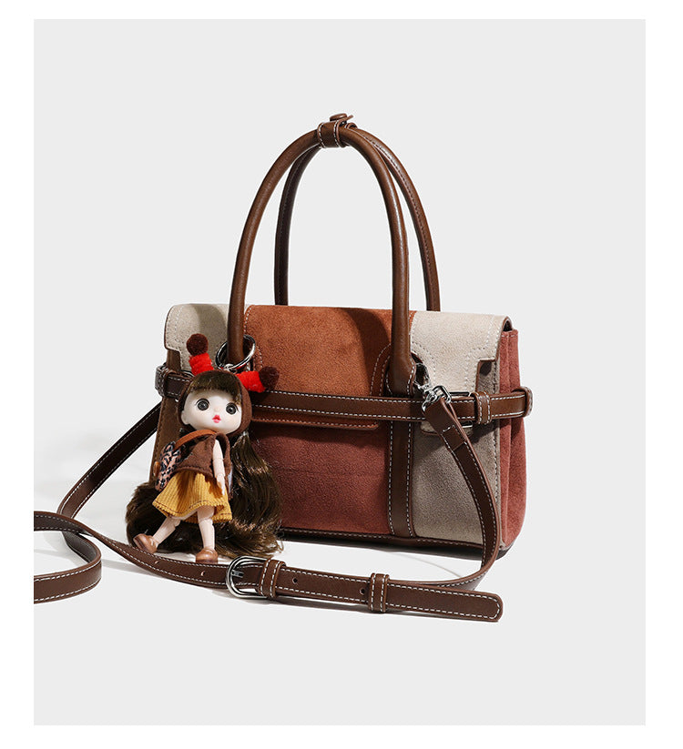 Structured color-block satchel bag in brown, rust, beige, and taupe suede-look panels with white topstitching, front buckle