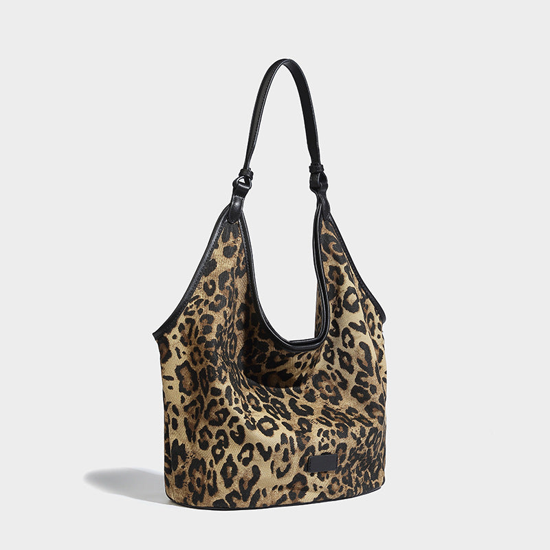 Slouchy brown leopard jacquard hobo tote bag with black leather-look trim and single shoulder strap, shown with black, detail