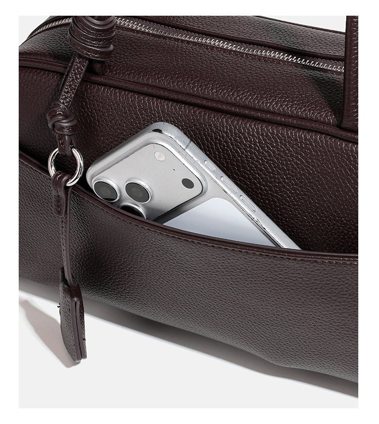 Structured rounded rectangular shoulder bag with pebbled leather-look finish, dual long handles, top zipper, front zip