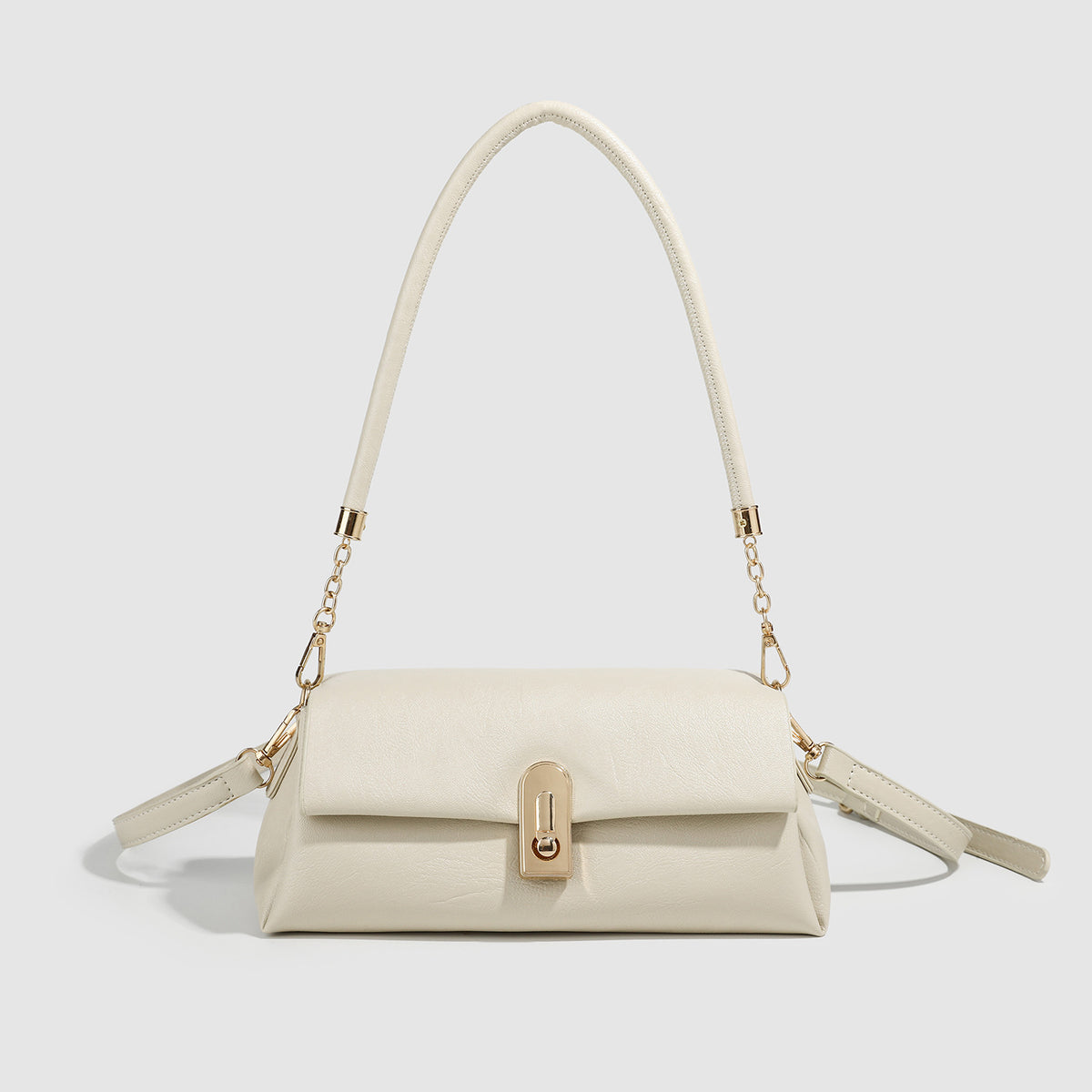 Small structured ivory baguette flap bag with gold-tone turn-lock hardware and chain-linked top handle, front view