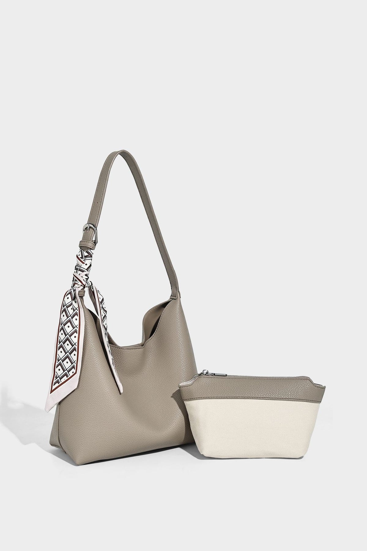 Soft slouchy hobo shoulder bag in pebbled matte finish with slim strap, silver-tone ring hardware, and knotted printed scarf