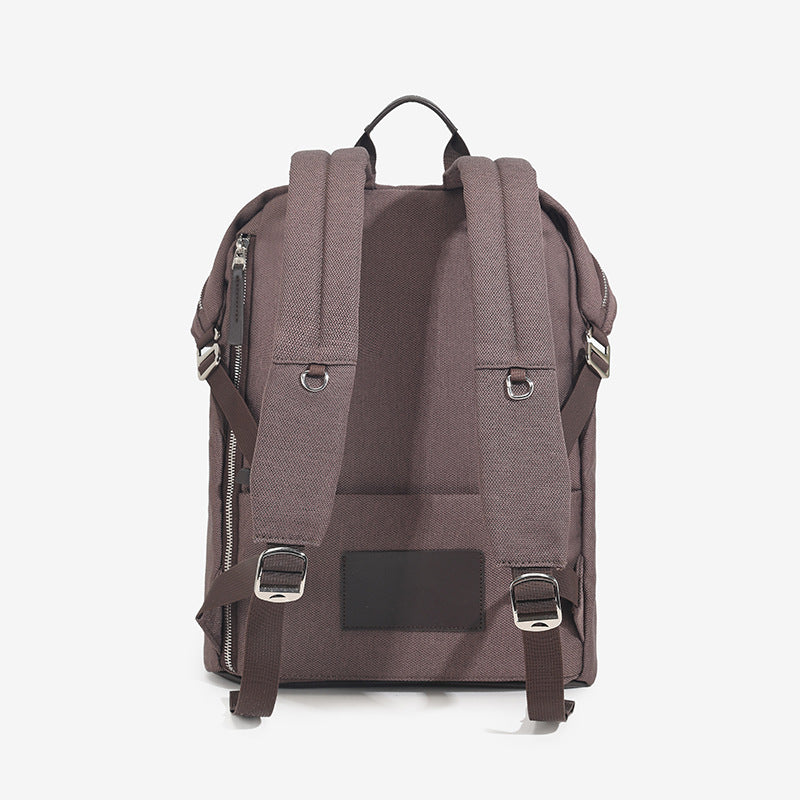 Structured matte nylon backpack with top zip closure, front zip pocket, top carry handle, and adjustable shoulder straps