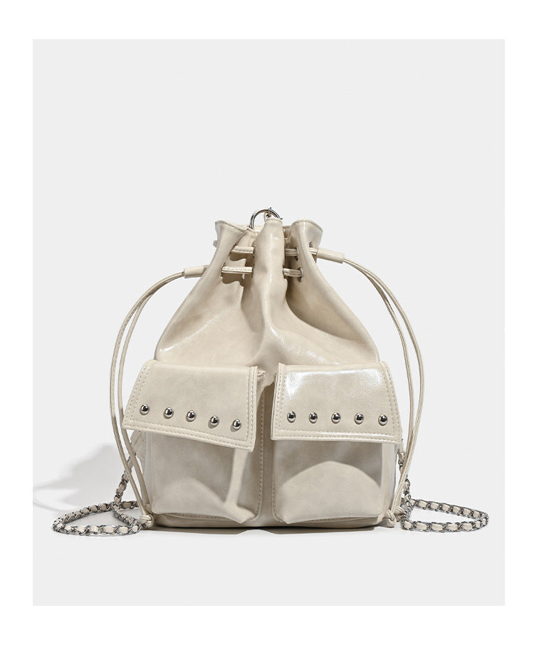 Glossy leather-look drawstring bucket bag with silver dome studs and chain shoulder strap, detail view 16
