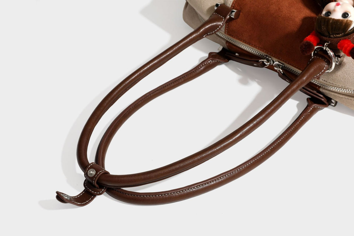 Patchwork suede-look barrel shoulder bag in brown, rust, tan, beige, and gray panels with double leather-look straps and