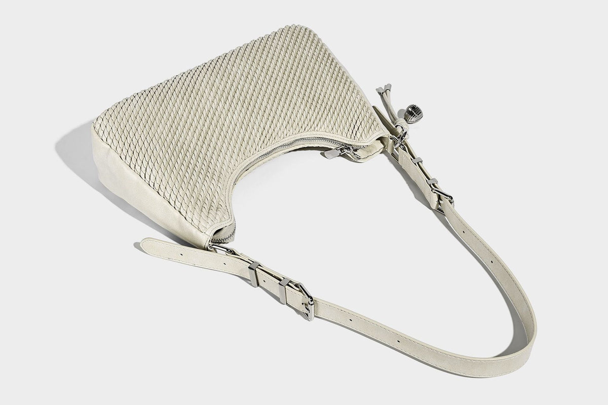 Woven crescent hobo shoulder bag with smooth side panels, zip-top closure, silver-tone charm hardware, and adjustable, detail