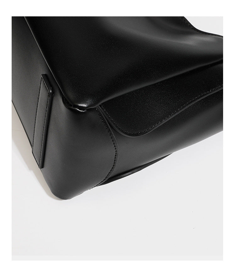 Structured glossy leather-look tote shoulder bag with dual top handles, detachable crossbody strap, side pockets, and, detail