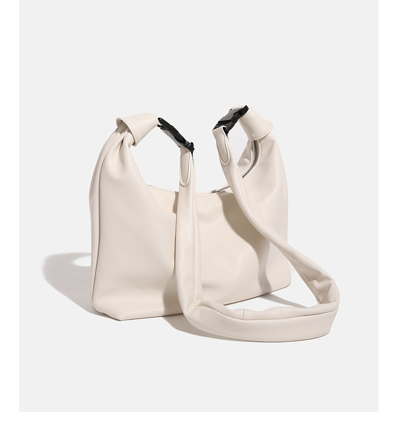 Slouchy leather-look hobo bag with knotted loop handle and top zipper closure, detail view 13