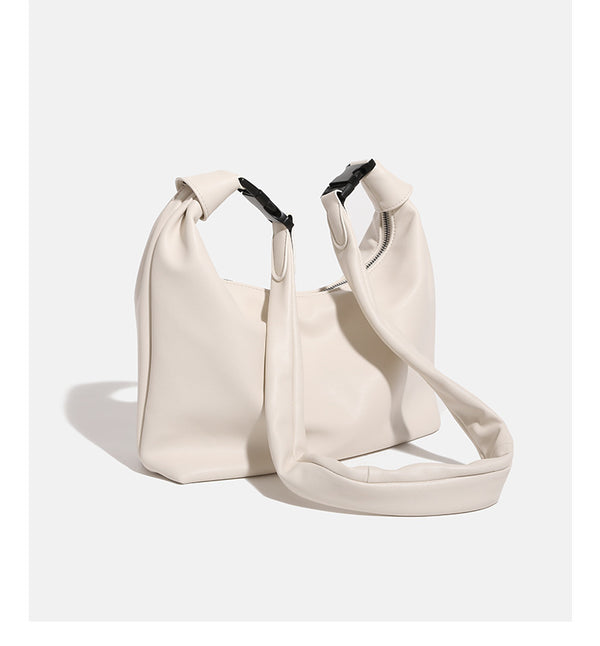 Slouchy leather-look hobo bag with knotted loop handle and top zipper closure, detail view 13