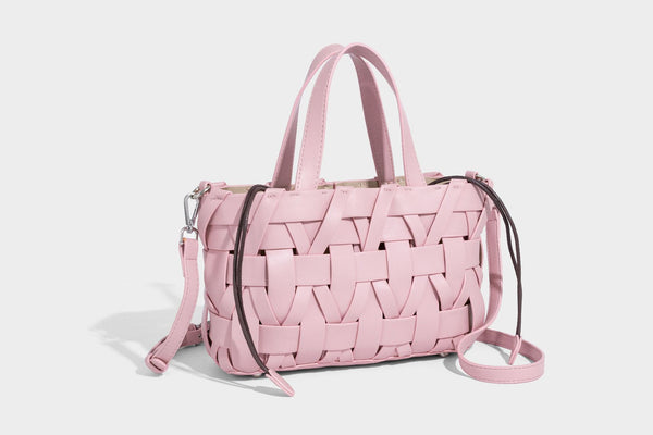 Structured woven basket tote handbag with contrasting dark trim, double top handles, detachable shoulder strap, and