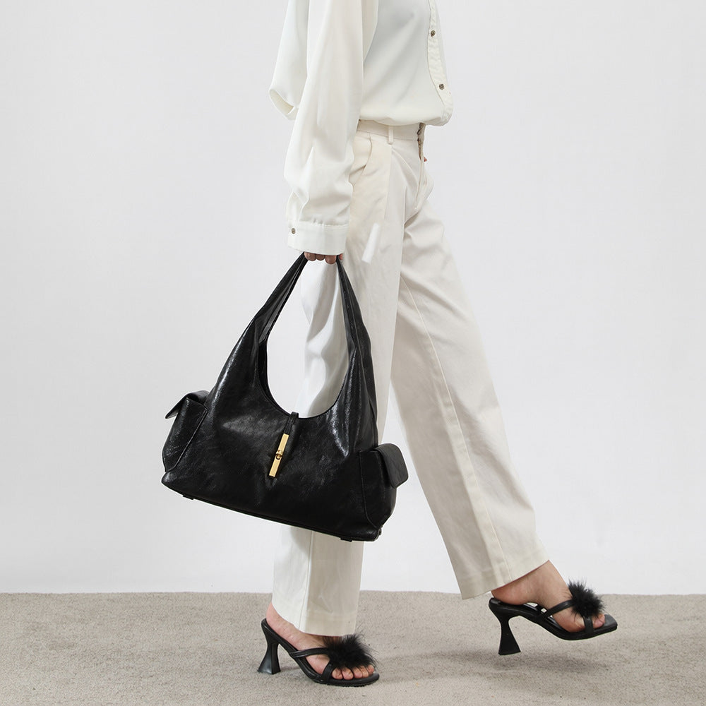 Slouchy leather-look hobo shoulder bag with gold-tone bar clasp and crinkled glossy finish, detail view 7